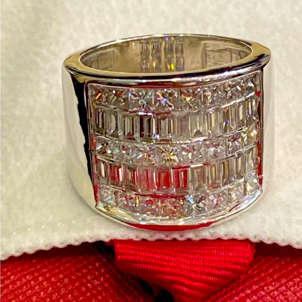 This extraordinary ring is also invisible set with over six carrots of Diamonds